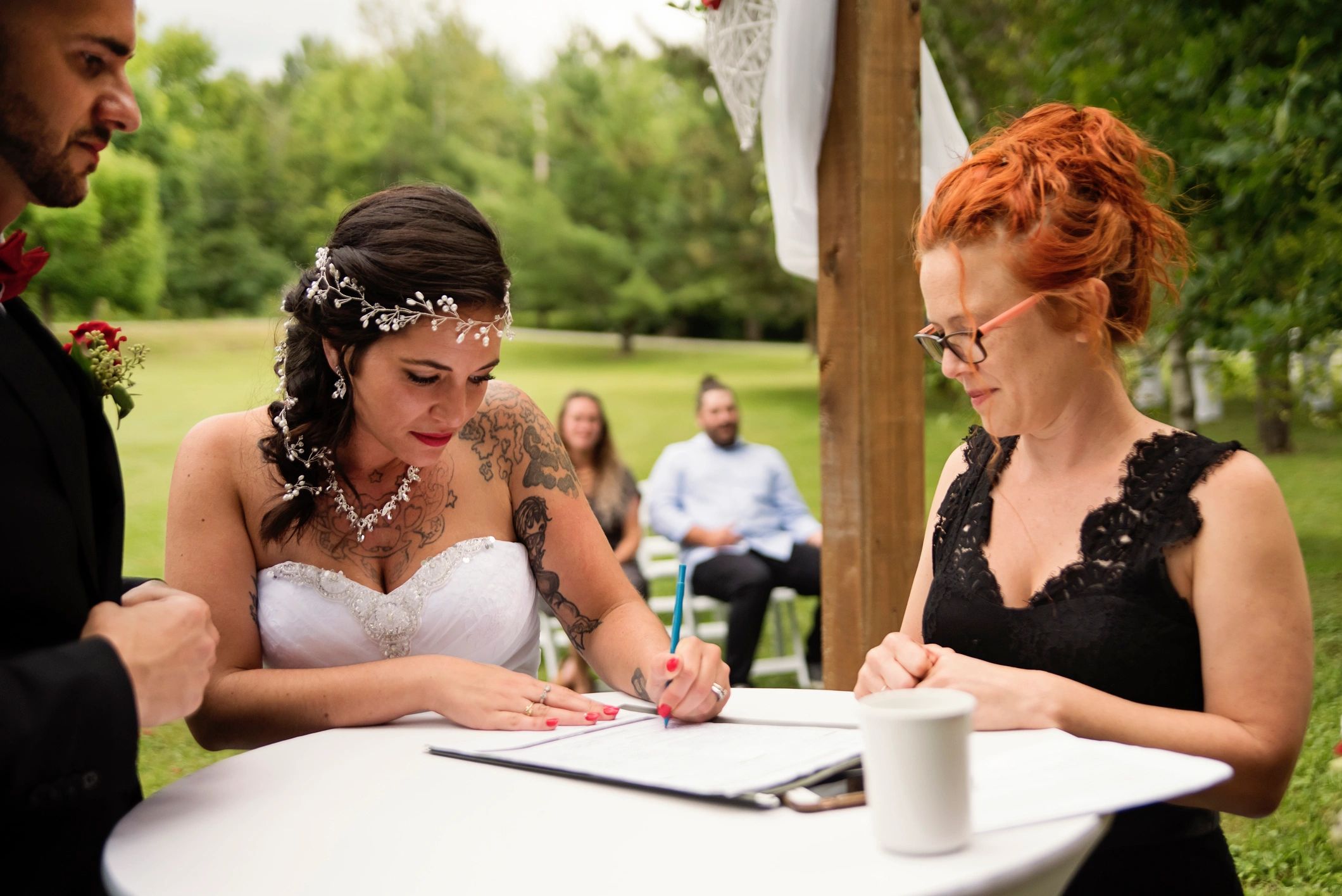Couple reviewing and signing marriage documents