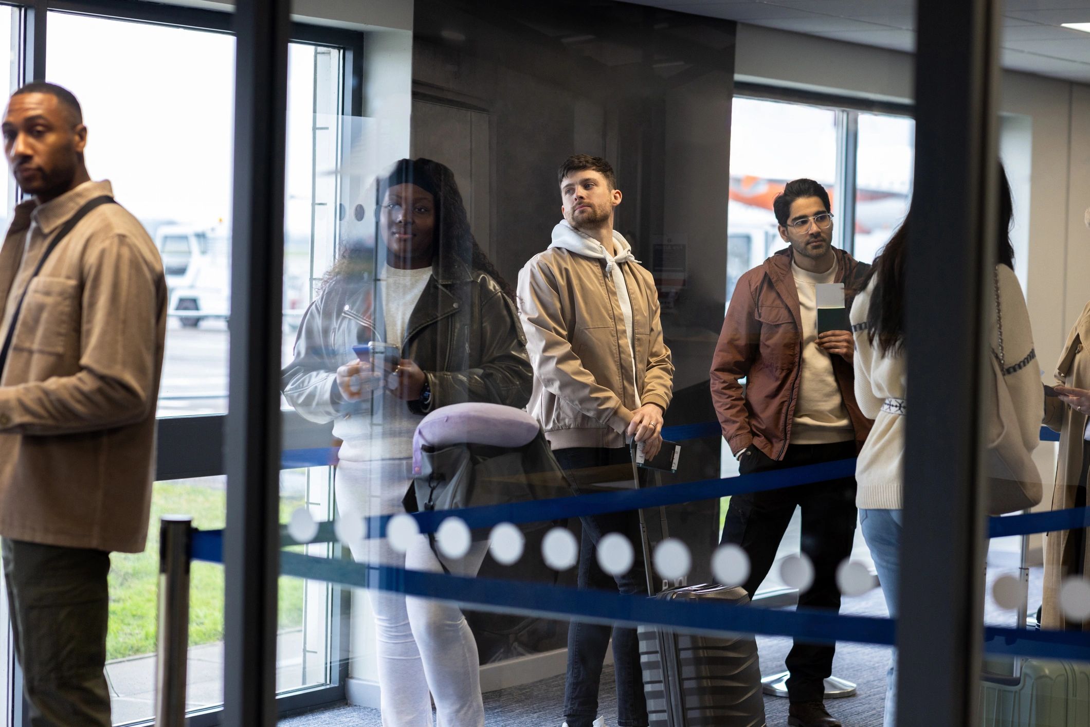 Travelers preparing documents at an airport
